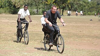 Felix Loch und malawische Kinder fahren Fahrrad